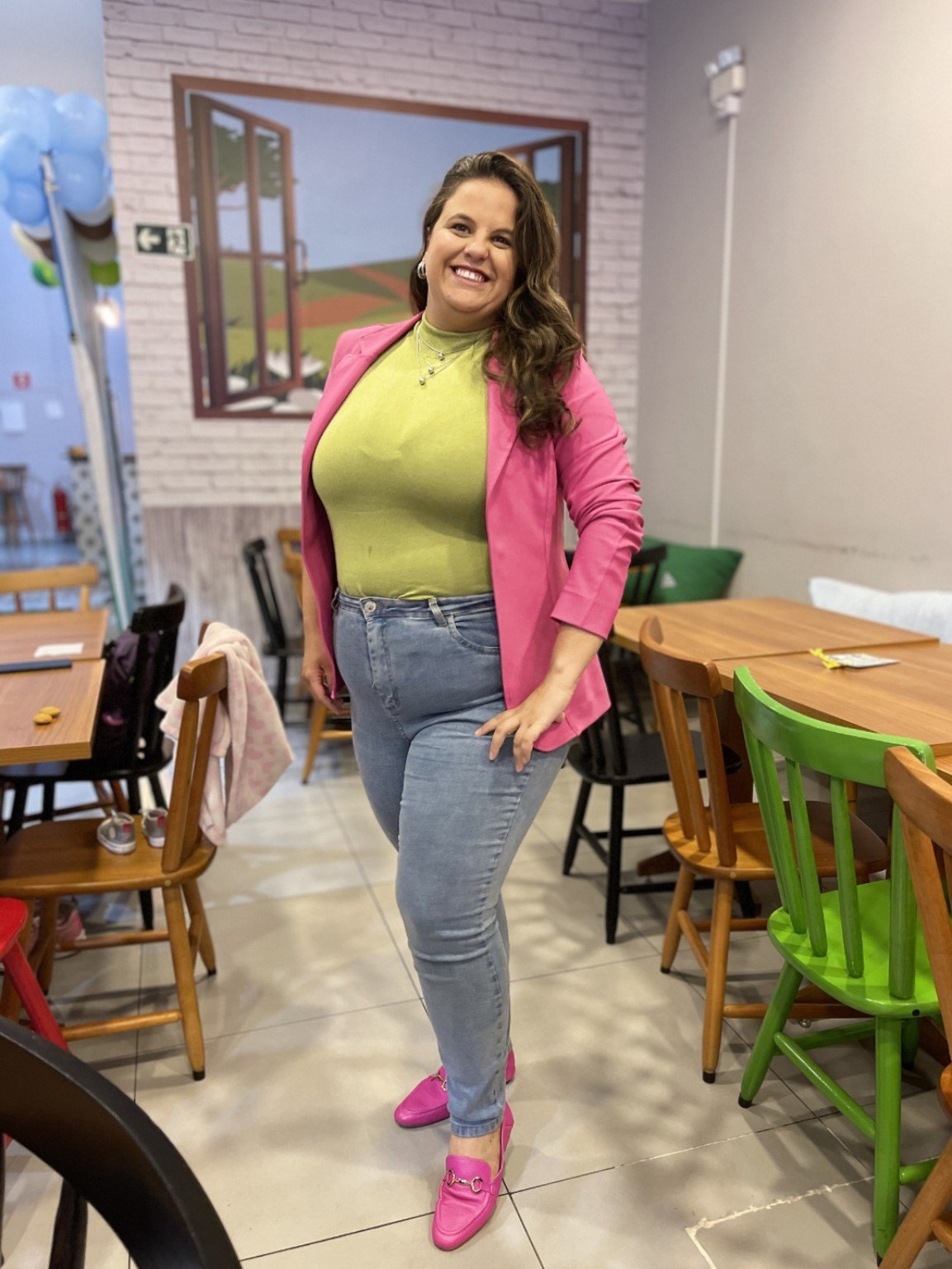 Isis Oliveira smiling in a pink blazer