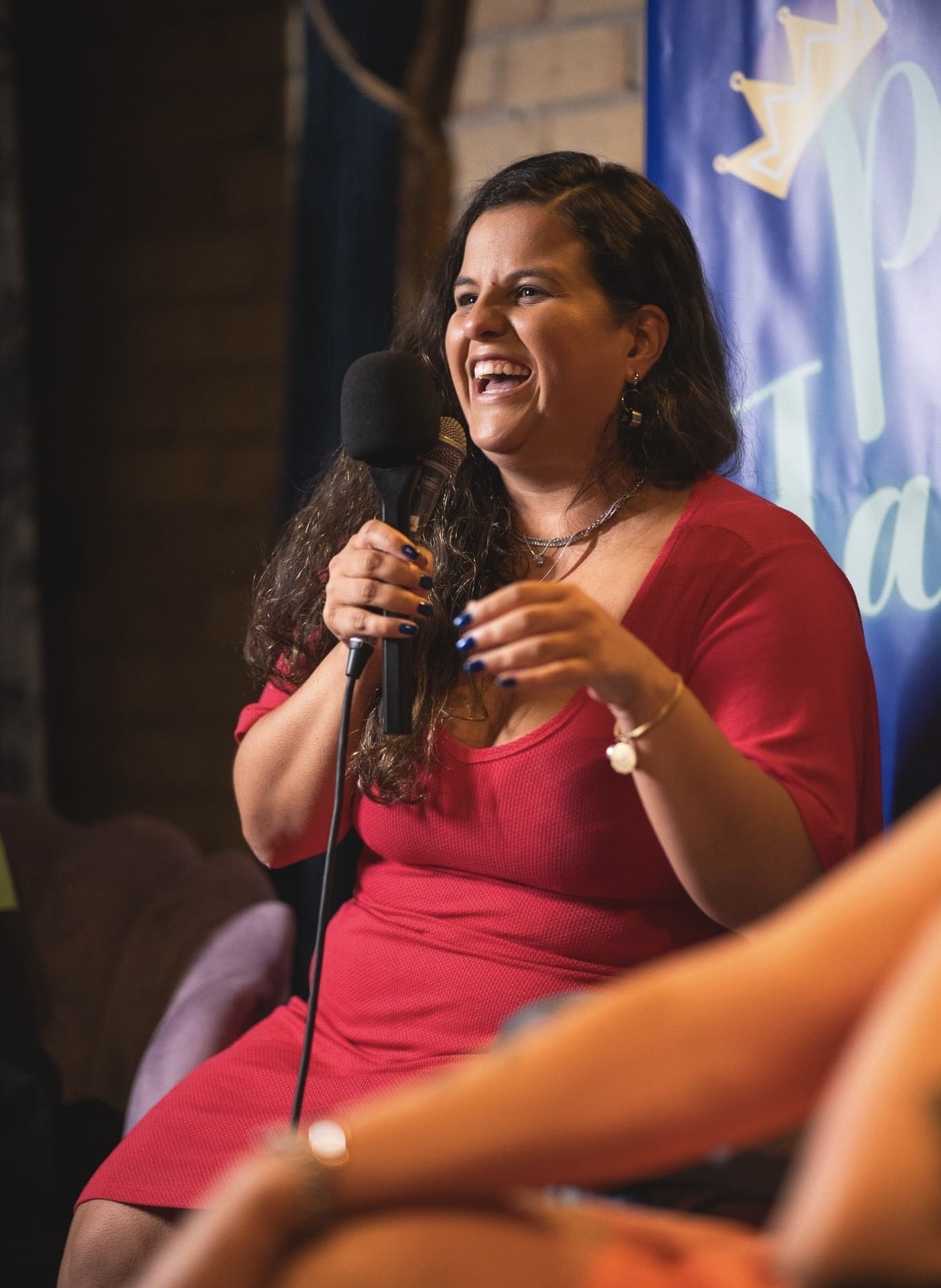 Isis Oliveira speaking with a microphone