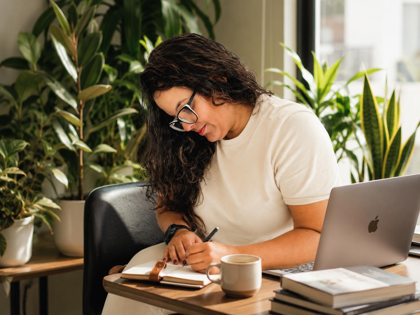 Isis Oliveira writing in a notebook